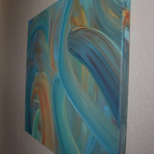 May include: Abstract painting on canvas with swirling blue, green, and orange brushstrokes.