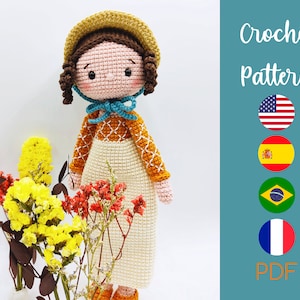 Puede incluir: Patrón de crochet PDF para una muñeca con cabello castaño, un sombrero de paja y un vestido azul y blanco. El patrón está disponible en inglés, español, francés, portugués y alemán.