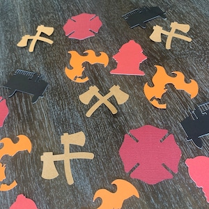 May include: Assortment of red, orange, and black paper cutouts of fire truck, fire hydrant, axe, and flames. The cutouts are on a woodgrain surface.
