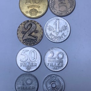 May include: A collection of Hungarian coins, including 10, 5, 2, and 1 Forint coins, as well as 50, 20, 10, and 2 Filler coins.