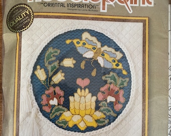 May include: Sunset Needlepoint "Oriental Inspiration" embroidery kit featuring a blue and yellow butterfly with floral accents on a white canvas. The kit includes 100% wool yarn and complete instructions.