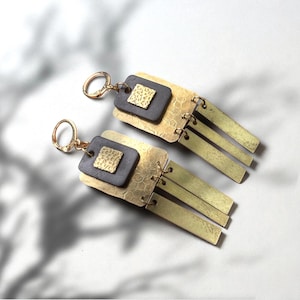 Recycled inner tube brass tassel earrings.