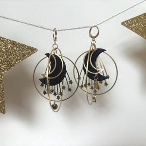Asymmetrical brass star earrings. Moons made from recycled inner tubes.