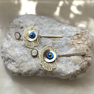 Earrings made from painted brass and recycled inner tube.