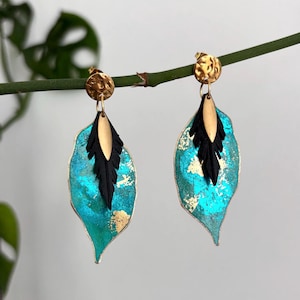 Turquoise leaf and feather earrings made from recycled inner tubes.