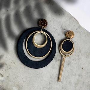 Asymmetrical brass and recycled inner tube earrings.
