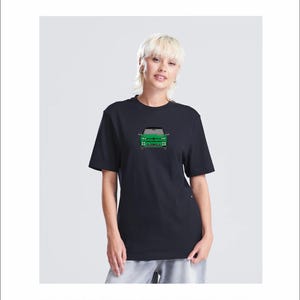 May include: Black t-shirt with a green car graphic on the front. The shirt has a crew neck design. The text at the bottom of the image reads: BLACK T-SHIRT WITH GREEN CAR.