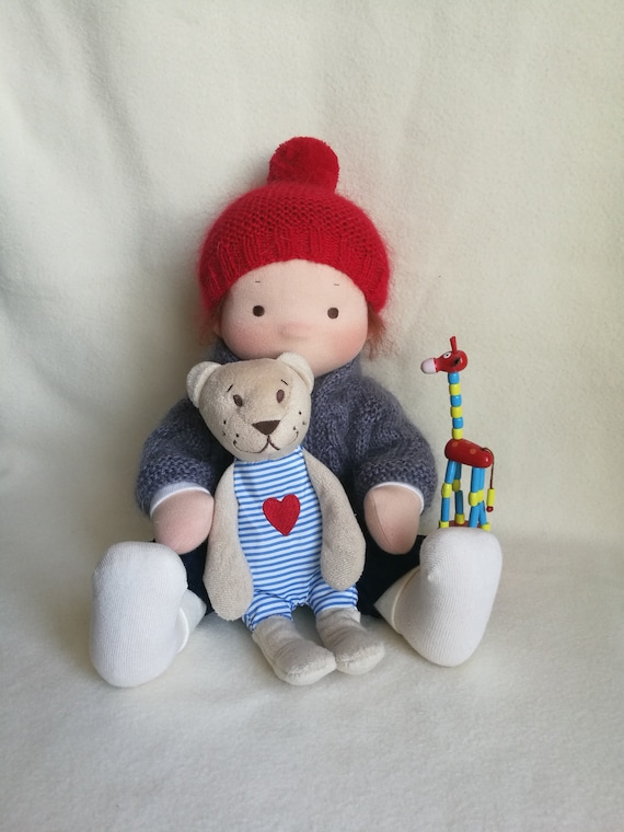 Textile doll with a set of clothes