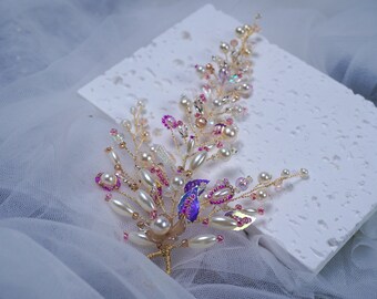 May include: A delicate gold hair comb adorned with white pearls, pink beads, and iridescent accents. The comb is designed in a cascading branch shape.