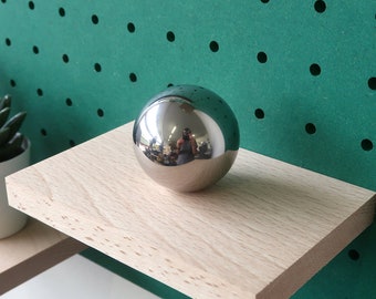 decorative polished metal sphere and its stabilizing platform