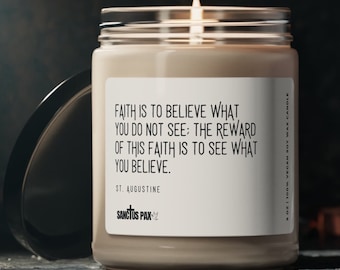 May include: A beige soy wax candle with a white label that reads "FAITH IS TO BELIEVE WHAT YOU DO NOT SEE: THE REWARD OF THIS FAITH IS TO SEE WHAT YOU BELIEVE. ST. AUGUSTINE SANCTUS PAX" and a small cross symbol. The candle is in a clear glass jar with a black lid.