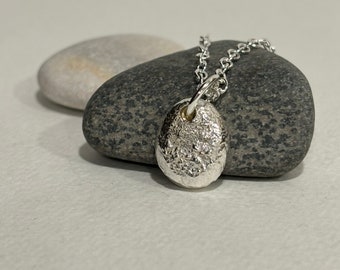 Silver pebble textured pendant necklace