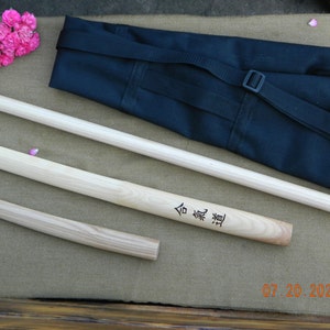 A set of wooden weapons for aikido - Bokken daito-ryu, jo, tanto - from ash and a bag for carrying and storage.