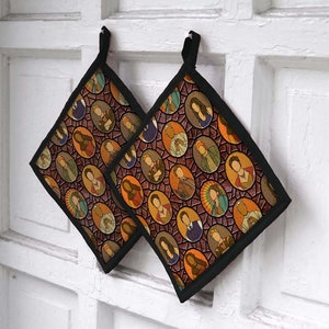 May include: Two black oven mitts with a colorful pattern of people in stained glass style. The mitts are hanging on a white wall.