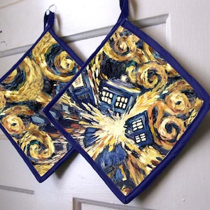 May include: A pair of blue and yellow pot holders with a painting of a starry night sky and a blue police box.