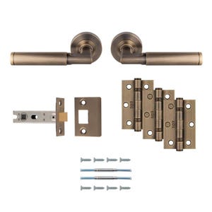 May include: A selection of antique brass door furniture, including two door handles, a door latch, door hinges, and screws. The hardware has a warm, aged finish, suggesting a vintage or classic style.