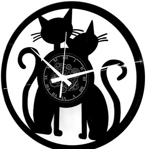 May include: Black cat-themed wall clock. The clock features two cat silhouettes within a circular frame. The clock face has Roman numerals and a gear design. The clock hands are white. The clock is made from a vinyl record.