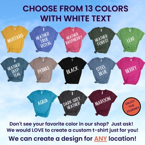 May include: A selection of 13 t-shirt colors with white text. The colors include mustard, heather true royal, heather raspberry, heather forest, leaf, heather deep teal, pebble, black, steel blue, berry, aqua, dark grey heather, and maroon. The text on the shirts reads "Choose from 13 colors with white text".