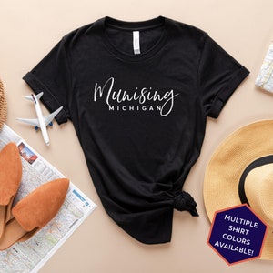 May include: Black t-shirt with white text that reads "Munising Michigan".