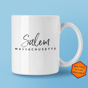 May include: White ceramic mug with black text that reads "Salem MASSACHUSETTS".