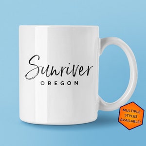 May include: White ceramic coffee mug with black text that reads "Sunriver Oregon".