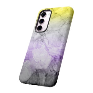 May include: A phone case with a marble pattern in shades of gray, purple, and yellow. The case has a raised camera bump and a black border.