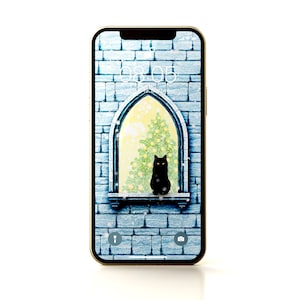 May include: A gold iPhone with a blue brick wall background. The phone screen shows a black cat sitting in a window with a Christmas tree behind it. The time on the screen is 08:05.