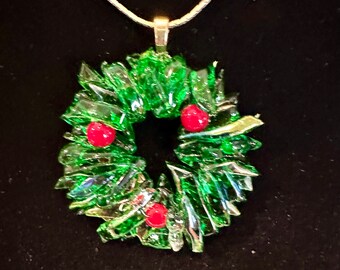 Christmas wreath pendant in Fused glass made with different shades of green and some clear glass with red berries