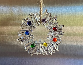 Fused glass Christmas wreath ornament in clear glass with rainbow colored berries