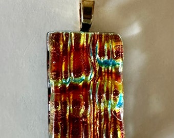 Fused Glass dichroic glass pendant in a beautiful combination of red gold orange with a hint of blue