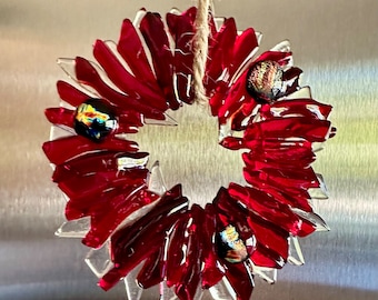 Fused glass Christmas wreath in different shades of transparent and opaque red and clear glass  -  with dichroic berries and flakes