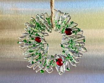 Fused glass ornament in clear glass with sprinkle of green glass and red berries