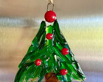 Fused glass tree ornament in different shades of green glass with some clear glass and red berries