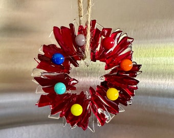 Fused glass Christmas wreath in different shades of transparent red and clear glass  -  with rainbow berries