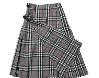 May include: A gray, black, and red plaid wrap skirt with a pleated front and a black buckle closure.