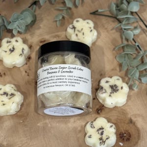 May include: A set of three ceramic mugs with a speckled, matte finish. Each mug features a different color: light blue, cream, and gray. The mugs have a simple, modern design and a comfortable handle.