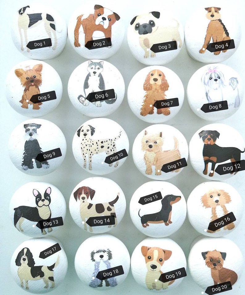 May include: A set of twenty round white wooden cabinet knobs, each featuring a unique hand-painted dog illustration labeled with black tags from Dog 1 to Dog 20, showcasing various breeds including pugs, dalmatians, and dachshunds.