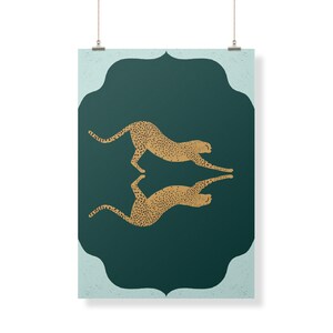 May include: A teal green poster with a gold cheetah silhouette design. The cheetah is facing right and is in a leaping pose. The cheetah is mirrored on the other side of the poster, facing left. The poster has a decorative border.