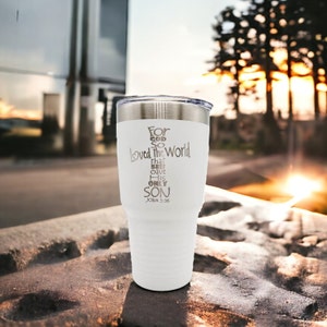 May include: White stainless steel tumbler with a silver inscription that reads "For God so loved the world that He gave His only Son John 3:16".