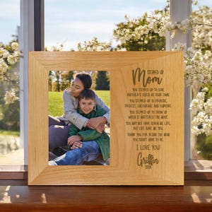 May include: A wooden photo frame with a personalized message for a mother. The message reads "Stepped Up Mom" and includes a poem about the love and support a mother provides. The frame includes a photo of a woman and a child.