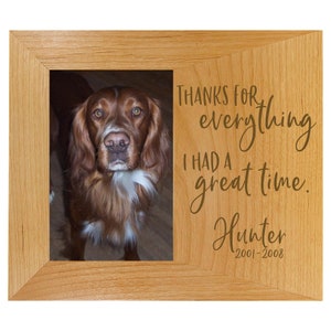 May include: A wooden picture frame with a photo of a brown dog. The frame has an engraved message that reads "Thanks for everything I had a great time. Hunter 2001-2008".
