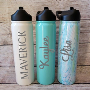 May include: Three stainless steel water bottles with black lids and personalised names. The bottles are white, turquoise, and a white and blue marble pattern. The names are Maverick, Kaylee, and Lisa.