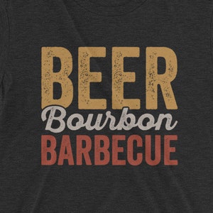 May include: A black t-shirt with the text "BEER Bourbon BARBECUE" in a vintage style font. The text is in shades of brown and red.