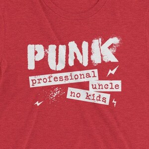 May include: Red t-shirt with white text that reads "PUNK professional uncle no kids" with lightning bolt symbols.