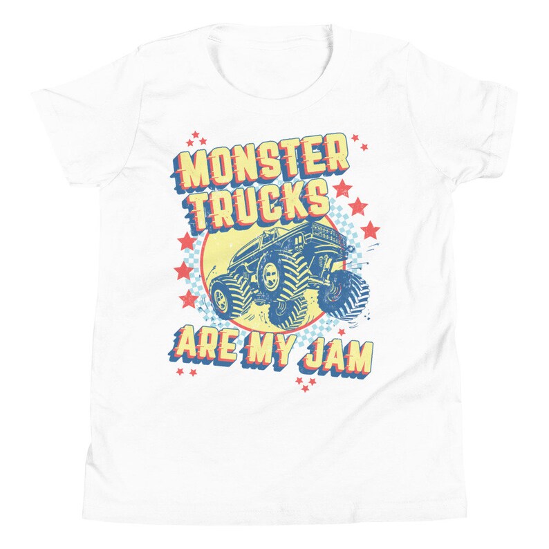 May include: White t-shirt with a retro-style graphic of a monster truck. The graphic features the text "Monster Trucks Are My Jam" in red, yellow, and blue lettering with stars around the truck.