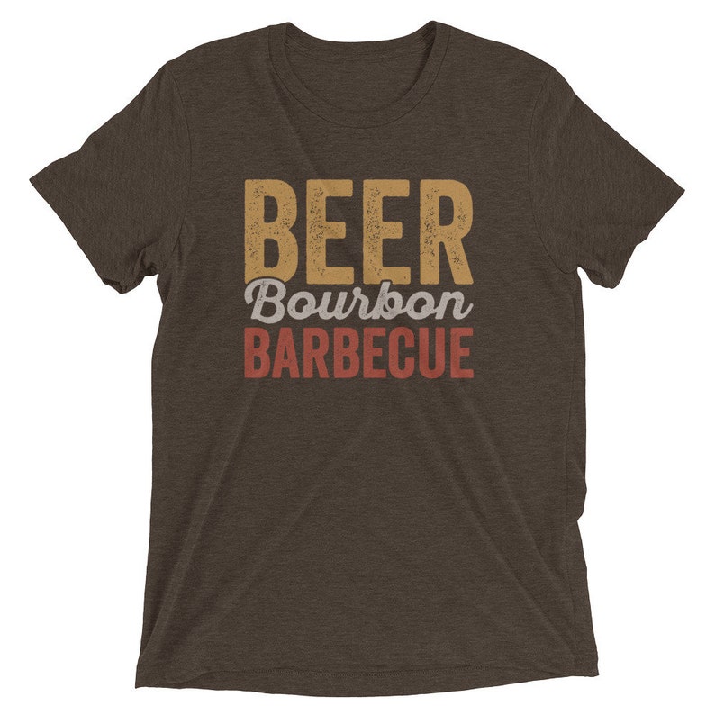 May include: A brown t-shirt with the text "BEER Bourbon BARBECUE" in a vintage style font.