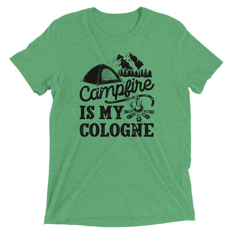 May include: Green t-shirt with a black graphic of a tent, campfire, and the text "Campfire is my cologne".