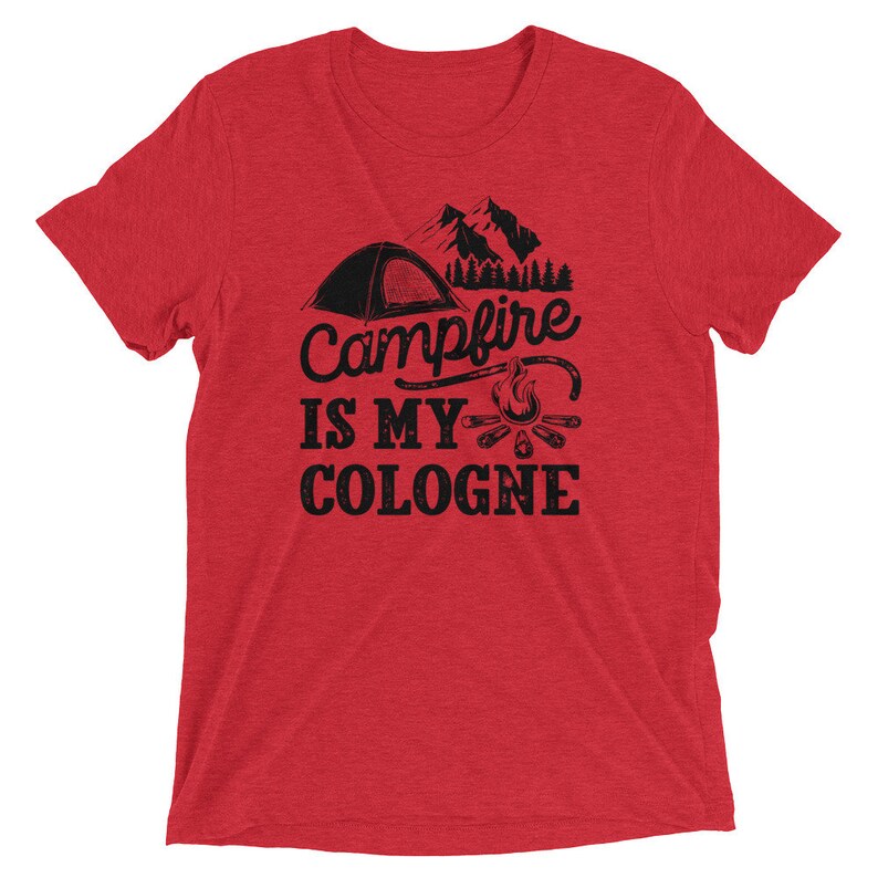 May include: Red short-sleeved t-shirt with a black graphic of a tent, mountains, and a campfire. The text reads "Campfire is my cologne".