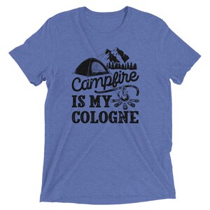 May include: A blue t-shirt with a graphic of a tent, mountains, a campfire, and the text "Campfire is my cologne".