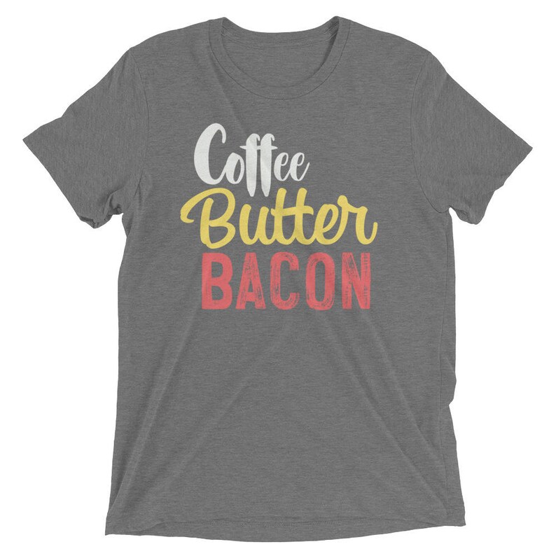 May include: Gray t-shirt with the text "Coffee Butter Bacon" in yellow, red, and white lettering.